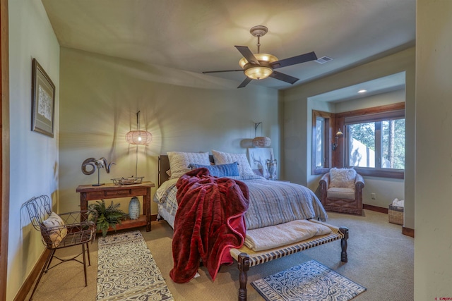 bedroom with ceiling fan and light colored carpet