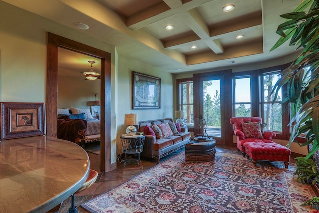 living room with beam ceiling, coffered ceiling, ceiling fan, and tile patterned floors