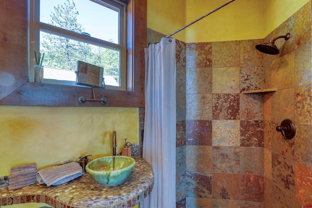 bathroom with curtained shower and sink