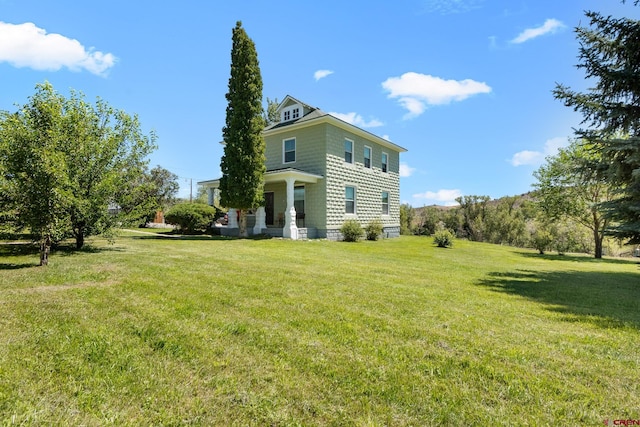 view of side of property with a lawn