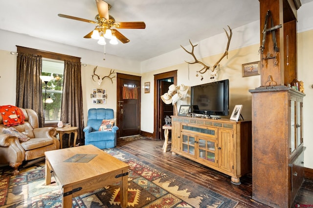 living room featuring ceiling fan and dark hardwood / wood-style floors