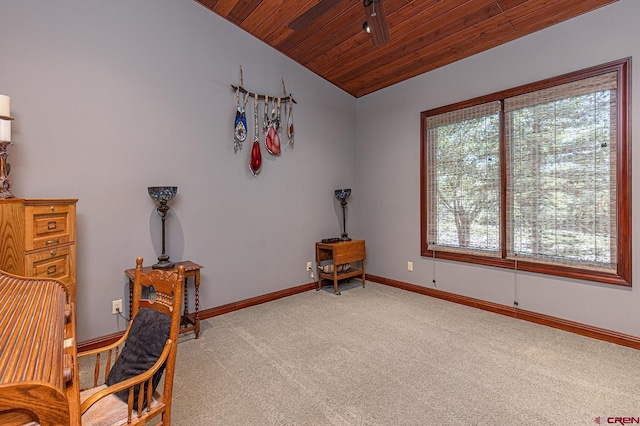 sitting room with wood ceiling, vaulted ceiling, ceiling fan, and carpet floors