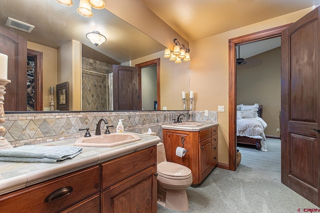 bathroom with tasteful backsplash, a shower, vanity, and toilet