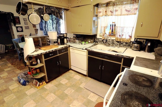 kitchen with dark brown cabinets, dishwasher, light stone counters, and sink