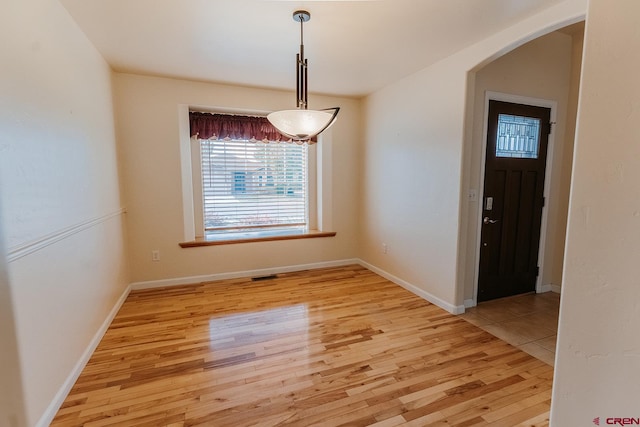 unfurnished dining area with light wood-type flooring