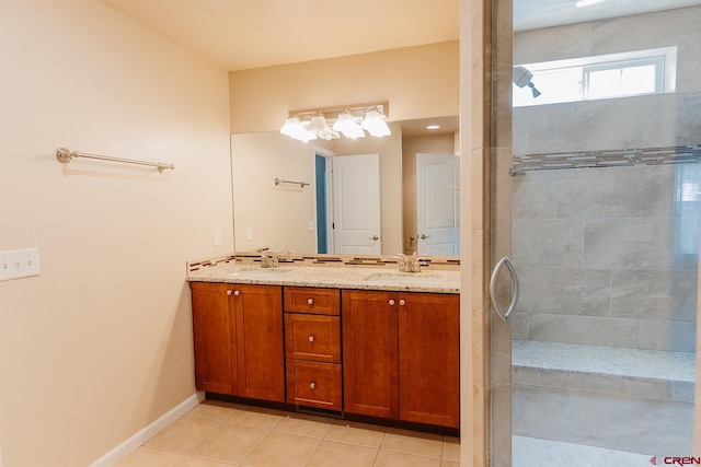 bathroom with a tile shower, tile patterned floors, and vanity