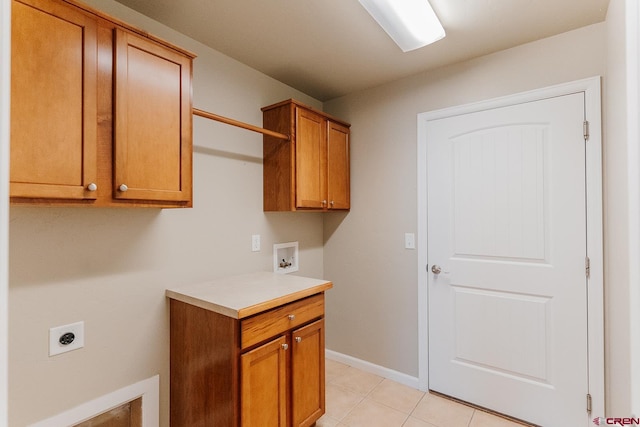 laundry room featuring light tile patterned floors, washer hookup, electric dryer hookup, and cabinets