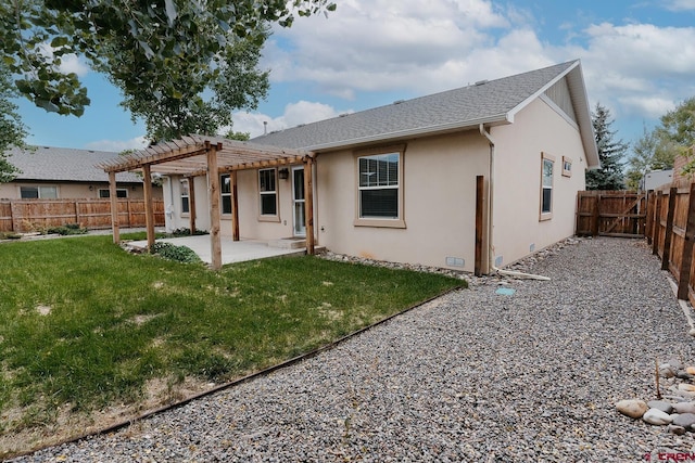 rear view of property with a pergola, a patio area, and a yard