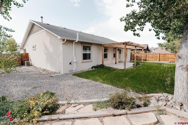 back of property with a pergola, a yard, and a patio area