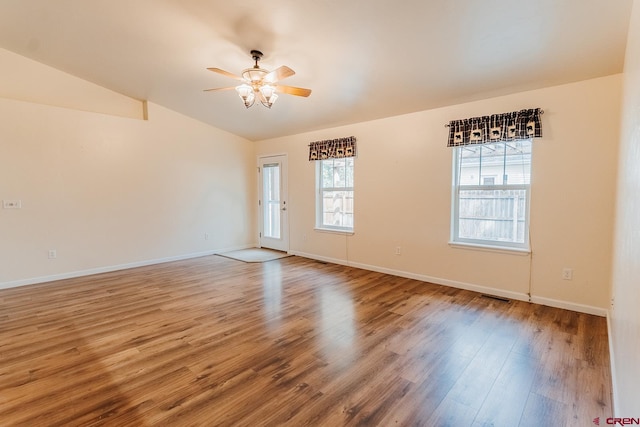 empty room featuring wood-type flooring, lofted ceiling, and ceiling fan