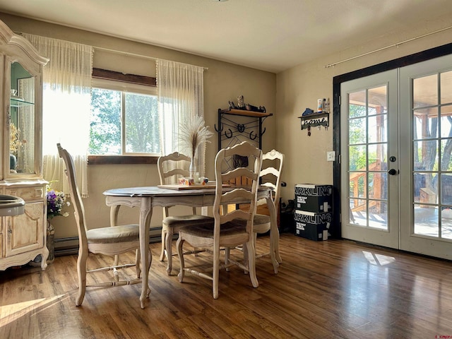 dining area with wood-type flooring, french doors, and a wealth of natural light