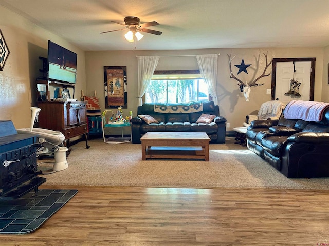 living room featuring ceiling fan and hardwood / wood-style flooring