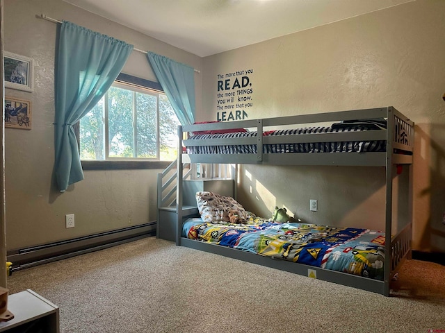 carpeted bedroom featuring a baseboard heating unit