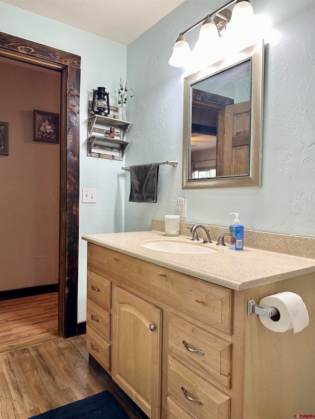 bathroom featuring vanity and hardwood / wood-style flooring