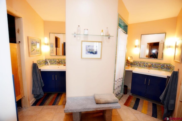 bathroom featuring vanity, a shower with shower curtain, tile patterned floors, and tasteful backsplash