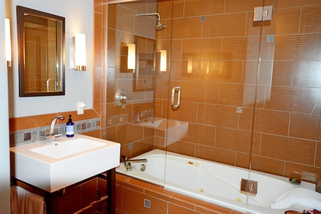 bathroom featuring vanity and enclosed tub / shower combo