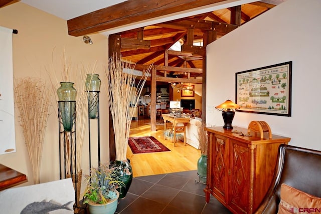 hallway with vaulted ceiling with beams and dark wood-type flooring