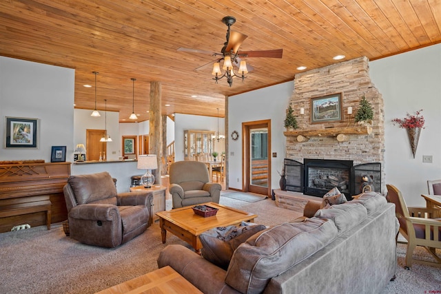 living room with a stone fireplace, carpet, and wood ceiling