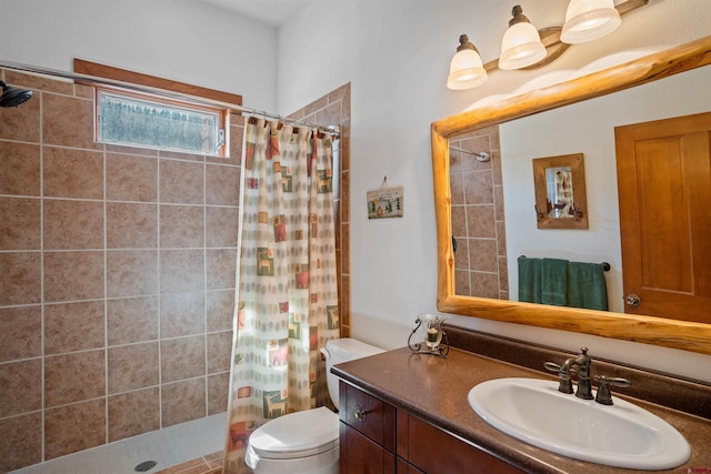 bathroom featuring walk in shower, vanity, and toilet