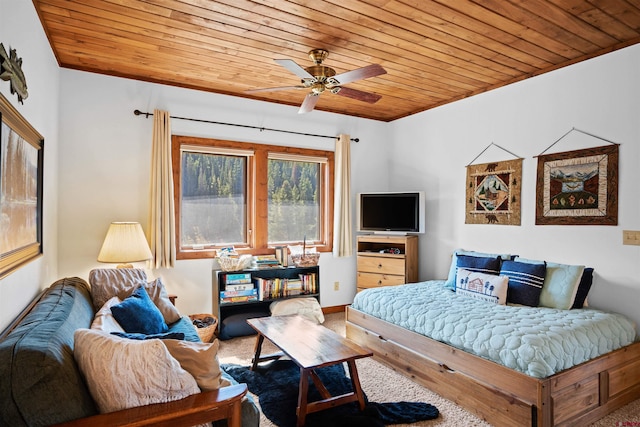 bedroom with ceiling fan, carpet floors, and wood ceiling