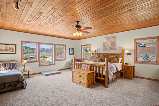 carpeted bedroom with wood ceiling and ceiling fan