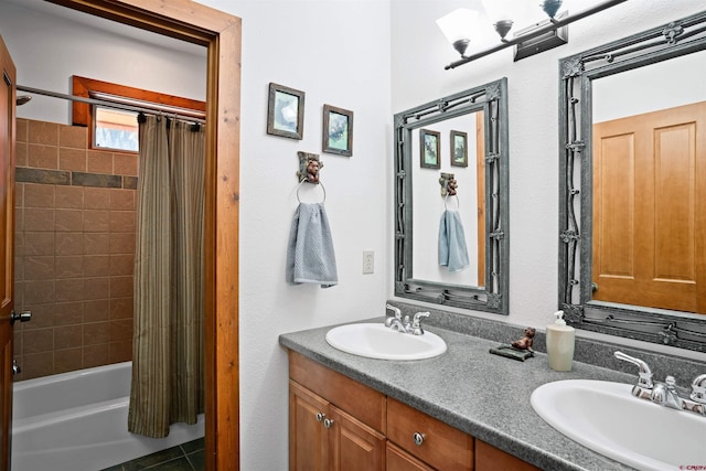 bathroom featuring tile patterned flooring, vanity, and shower / bath combo with shower curtain