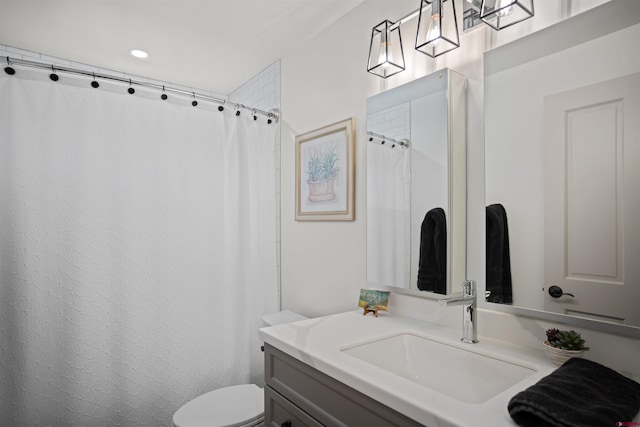 bathroom with a shower with curtain, vanity, and toilet