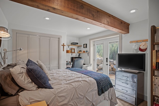 bedroom with light wood-type flooring, a closet, beam ceiling, access to outside, and french doors