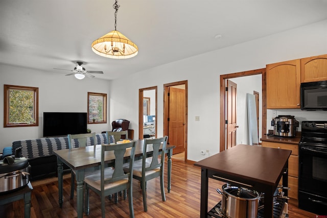 dining area with ceiling fan and hardwood / wood-style floors