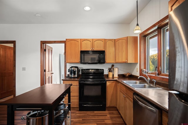 kitchen with hanging light fixtures, sink, dark hardwood / wood-style flooring, and black appliances