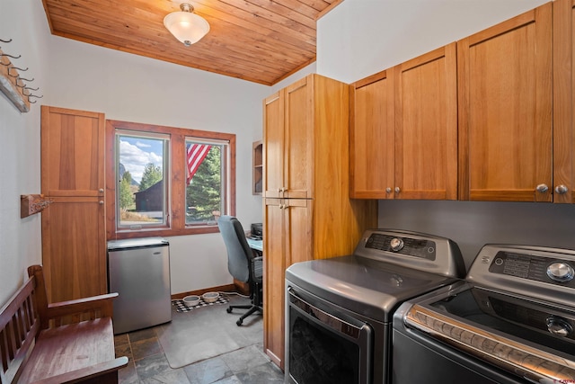 washroom featuring wooden ceiling, washing machine and clothes dryer, and cabinets