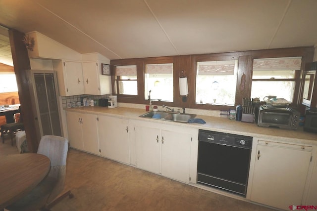 kitchen with white cabinets, black appliances, vaulted ceiling, and sink