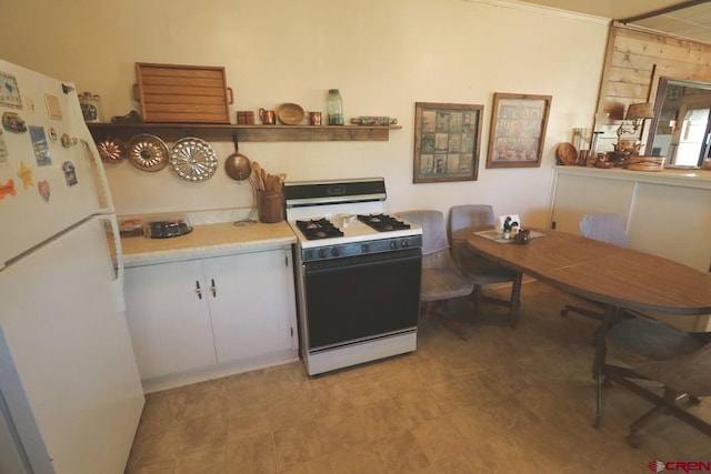 kitchen with white appliances and white cabinetry