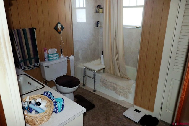 full bathroom featuring vanity, wood walls, toilet, and shower / tub combo with curtain