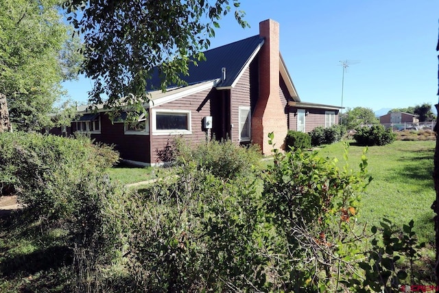 view of home's exterior with a lawn