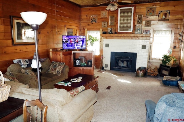 410 E Empire St, Cortez, CO 81321 - carpeted living room with wood walls, a fireplace, and a ceiling fan