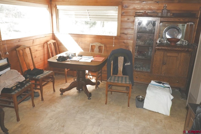 dining space featuring wooden walls