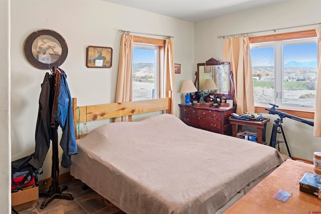 bedroom with a mountain view and hardwood / wood-style floors