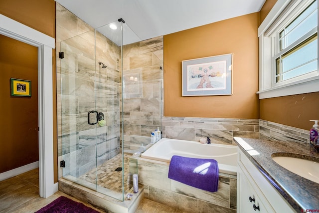 bathroom featuring tile walls, tile patterned floors, independent shower and bath, and vanity