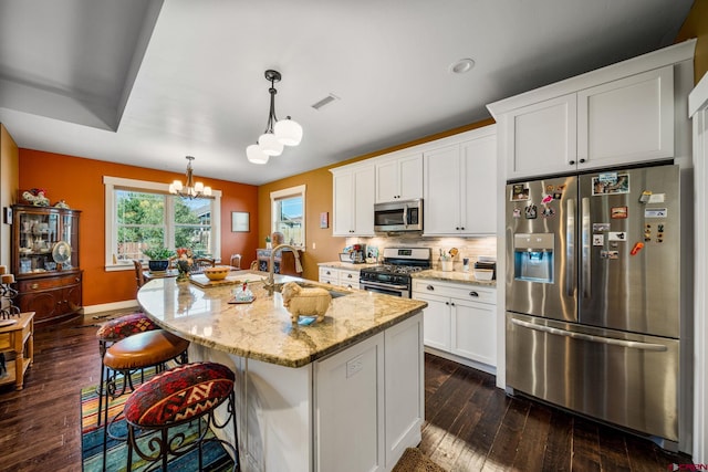 505 Prospector Ave, Durango, CO 81301 - kitchen with visible vents, a chandelier, appliances with stainless steel finishes, light stone counters, and a sink