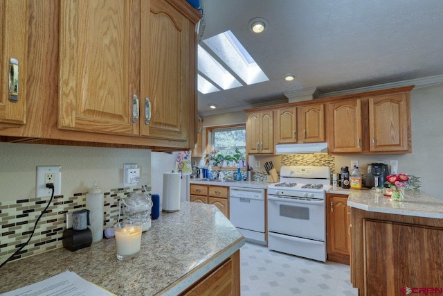 kitchen with a skylight, ornamental molding, and white appliances