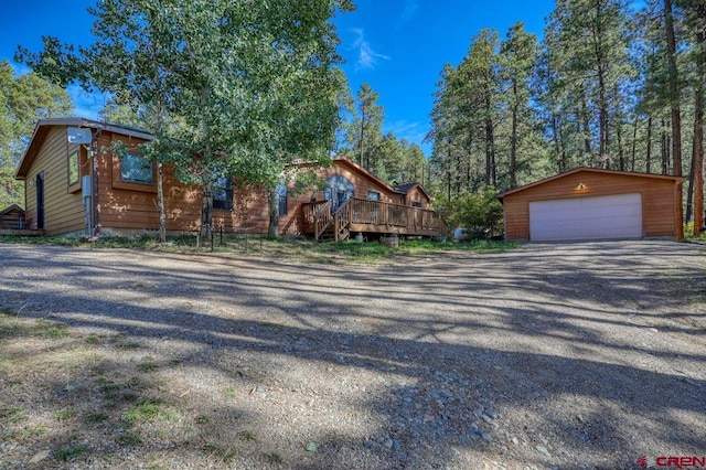 log home with an outdoor structure, a deck, and a garage