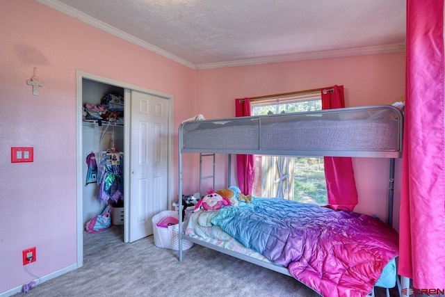 carpeted bedroom featuring ornamental molding, a closet, and a textured ceiling