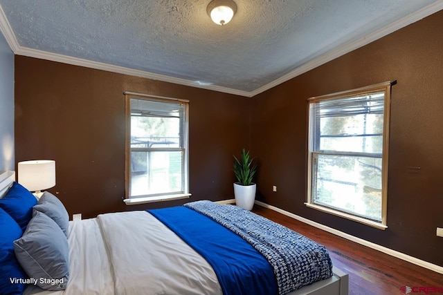 bedroom with ornamental molding, a textured ceiling, and dark wood-type flooring