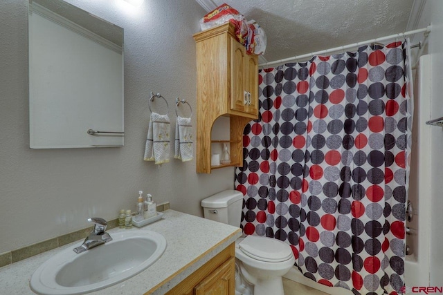 bathroom with a textured ceiling, crown molding, vanity, and toilet