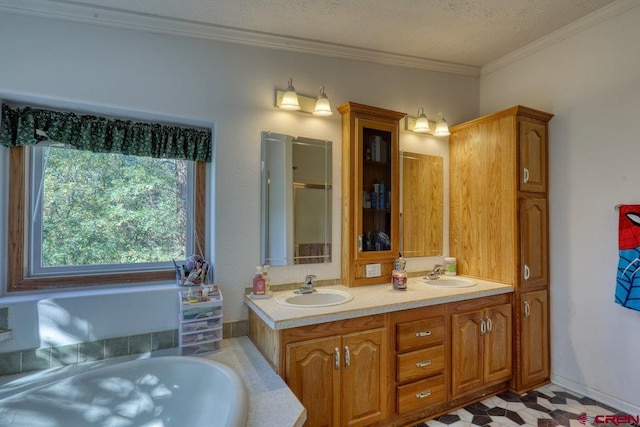 bathroom featuring vanity, a textured ceiling, a tub, and crown molding