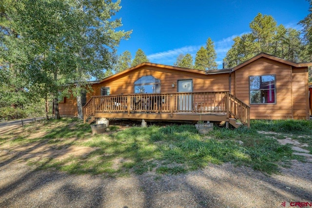 back of house with a wooden deck