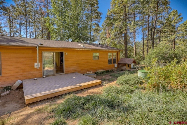 rear view of property featuring a wooden deck