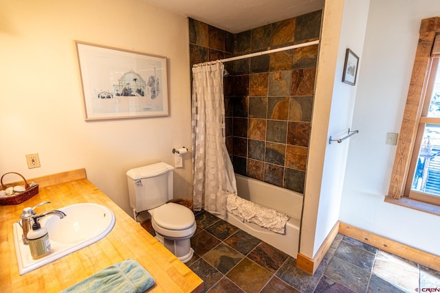 full bathroom featuring toilet, shower / bathtub combination with curtain, and sink