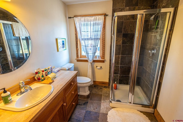 bathroom with vanity, toilet, and an enclosed shower